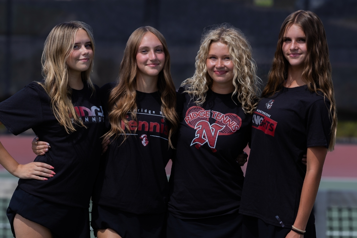 Four Northridge tennis players wearing all four shirt designs